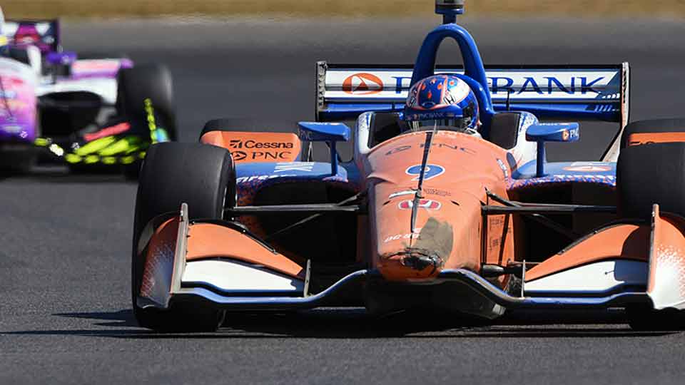 Scott Dixon emerges from the dust after a turn 1 incident